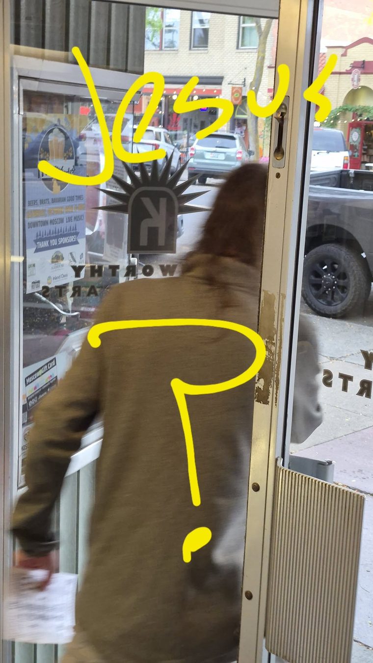 A bearded man entering a shop doorway